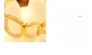 Detailed close-up of a gold-plated square cutout ring featuring minimalist hollow links