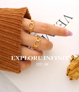 Close-up of golden geometric hollow chain rings on a hand for a modern minimalist look