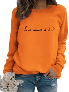 Close-up of bright orange sweatshirt featuring Hawaii script print and rib-knit crewneck