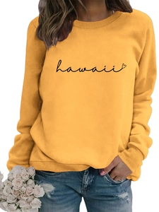 Detail of ginger yellow sweatshirt featuring black Hawaii lettering and heart print design