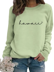 Detail of light green sweatshirt featuring black Hawaii script and heart print details