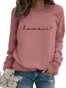 Detail of pink long sleeve sweatshirt with black Hawaii heart print and denim jeans