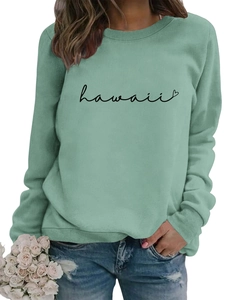 Detail of mint green sweatshirt featuring black Hawaii script and ribbed crew neckline