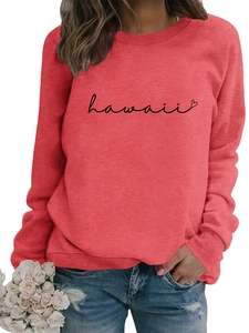 Detail of red crewneck sweatshirt featuring black cursive Hawaii print and heart pattern