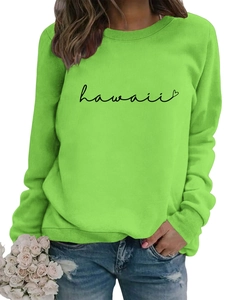 Close-up of grass green crewneck sweatshirt featuring Hawaii text and heart print details
