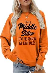 Detail of bright orange sweatshirt with black I'm the middle sister slogan print
