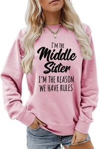 Close-up of pink crewneck sweatshirt featuring I'm the middle sister slogan and ribbed cuffs