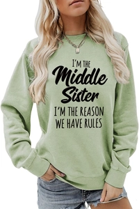 Detail of 'I'M THE Middle Sister' letter print on light green long sleeve sweatshirt