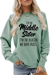 Detail of sage green sweatshirt with black text print I'm the middle sister slogan
