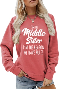 Close-up of I'M THE Middle Sister slogan print on red crewneck sweatshirt with ribbed cuffs