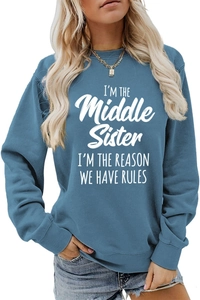 Detailed close-up of white letter print on a blue cotton blend long sleeve sweatshirt