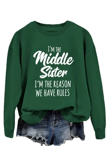 Detail view of dark green sweatshirt with I'm the Middle Sister white letter print