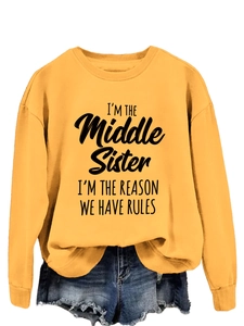 Detail of 'I'm the middle sister' print on mustard yellow crewneck long sleeve sweatshirt