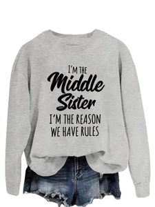Detail of grey sweatshirt with 'I'm the middle sister' quote and denim shorts