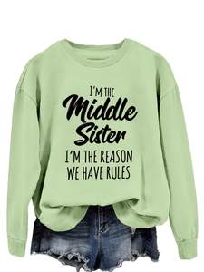 Detail view of mint green sweatshirt with I'm the Middle Sister slogan print