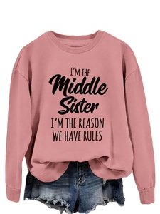 Detail of pink crewneck sweatshirt with 'I'M THE Middle SISTER' slogan print