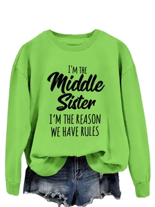 Detail of neon green sweatshirt featuring I'M THE MIDDLE SISTER black letter print