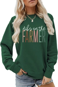 Detail of dark green crewneck sweatshirt with Dibs on the Farmer print and ribbed cuffs