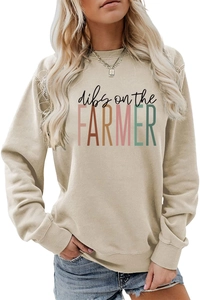 Detailed close-up of beige crewneck sweatshirt with colorful dibs on the FARMER print