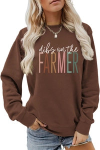 Detail of the brown crewneck sweatshirt with Dibs on the Farmer print and ribbed cuffs