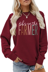 Detail of the Dibs on the Farmer graphic print on a burgundy crewneck sweatshirt