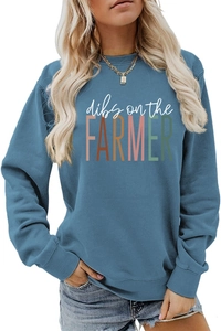 Detail of ribbed cuffs and slogan print on a blue crewneck sweatshirt for women