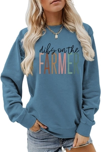 Detail of ribbed cuffs and vibrant dibs on the farmer print on blue sweatshirt