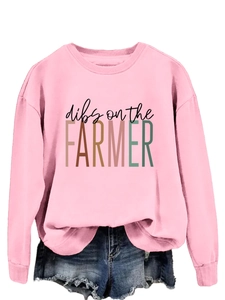 Detail of pink crewneck sweatshirt with Dibs on the Farmer print and denim shorts