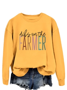 Detail showing yellow crewneck sweatshirt with Dibs on the Farmer print and denim shorts