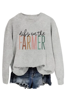 Detail of grey crewneck sweatshirt with 'Dibs on the Farmer' text and denim shorts