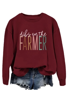 Close-up of dibs on the FARMER print on a burgundy oversized long sleeve crewneck sweatshirt