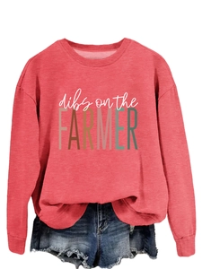 Close-up of red crewneck sweatshirt featuring dibs on the farmer retro slogan