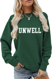 Detail of white UNWELL lettering print on a dark green crewneck sweatshirt