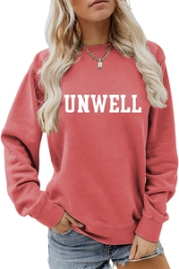Detail of the white UNWELL letter print on the chest of a casual pink sweatshirt