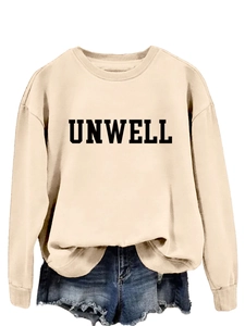 Detail of beige UNWELL letter print sweatshirt paired with frayed denim shorts