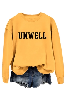 Detail of minimalist Unwell letter print on casual ginger yellow crewneck sweatshirt