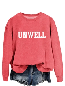 Detail of UNWELL printed lettering on a peach pink crewneck sweatshirt with raw hem denim shorts