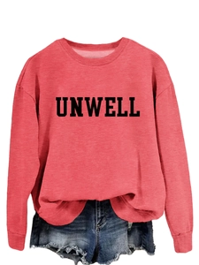 Detail of brick red sweatshirt featuring bold UNWELL print and frayed denim shorts