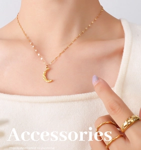 Detail of 18K gold plated crescent moon pendant necklace with textured finish and zircon