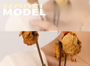Minimalist 18K gold-plated chain ring on a model with dried rose accents and soft lighting
