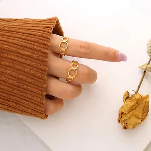 Minimalist square hollow gold ring set with a matte brushed finish on model's hand