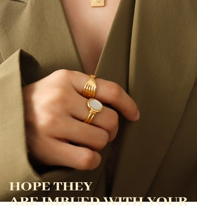 Detail showing vintage gold-plated rings with textured vertical lines and shell inlay detail