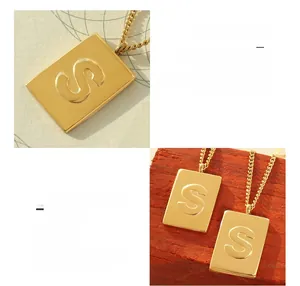 Detailed view of 18K gold plated titanium steel rectangle pendant with embossed letter S