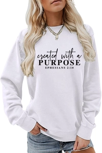 Detail of black printed lettering on a white crew neck sweatshirt showing fabric texture