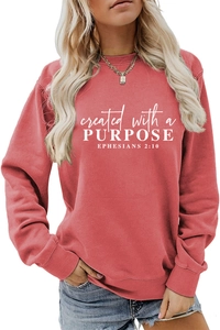 Close-up of retro rose red sweatshirt with white 'Created with a Purpose' slogan print
