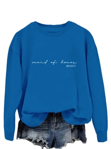 Close-up of royal blue crewneck sweatshirt featuring white Maid of Honor text and denim shorts
