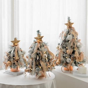 Mini flocked cedar Christmas trees set with warm lights and festive gold decorations