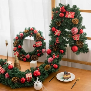 Christmas wreath and garland set with red ornaments, pine cones, and gift boxes decor
