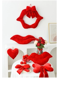 Close-up of luxury red velvet lip pillows and bow decor for Valentine's party