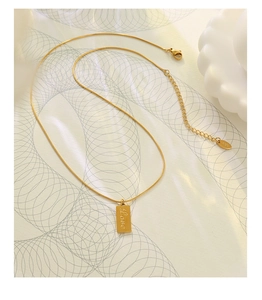 Detailed macro view of 18K gold plated snake chain with square Love pendant and clasp